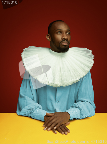 Image of Young man as a medieval grandee on red background