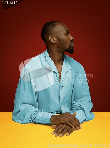 Image of Young man as a medieval grandee on red background