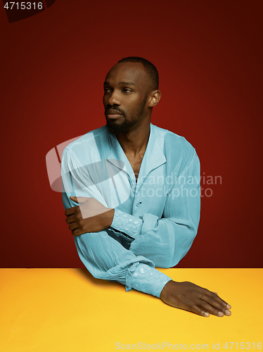 Image of Young man as a medieval grandee on red background