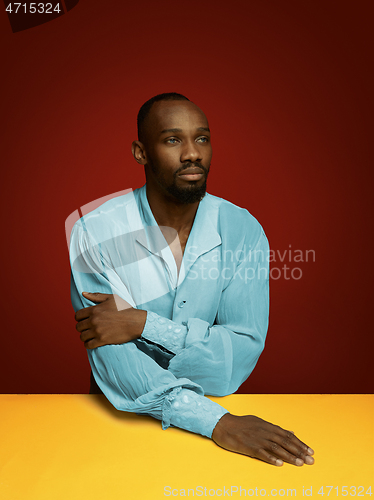 Image of Young man as a medieval grandee on red background