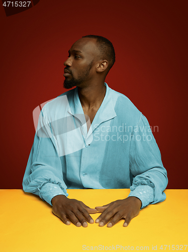 Image of Young man as a medieval grandee on red background