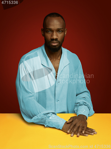 Image of Young man as a medieval grandee on red background