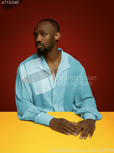 Image of Young man as a medieval grandee on red background