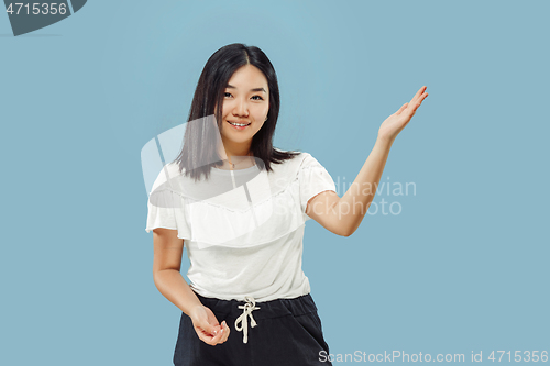 Image of Korean young woman\'s half-length portrait on blue background