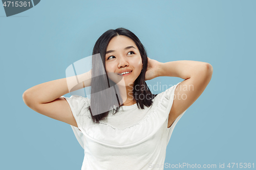 Image of Korean young woman\'s half-length portrait on blue background