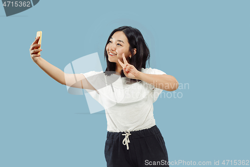 Image of Korean young woman\'s half-length portrait on blue background