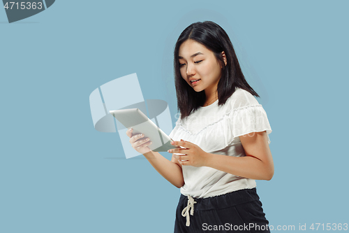 Image of Korean young woman\'s half-length portrait on blue background