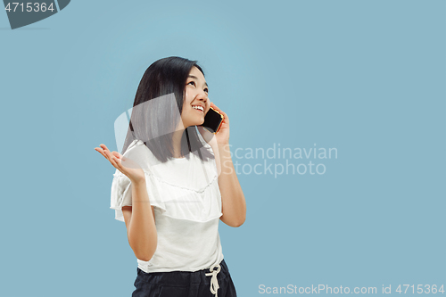 Image of Korean young woman\'s half-length portrait on blue background