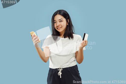 Image of Korean young woman\'s half-length portrait on blue background