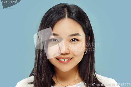 Image of Korean young woman\'s close up portrait on blue background