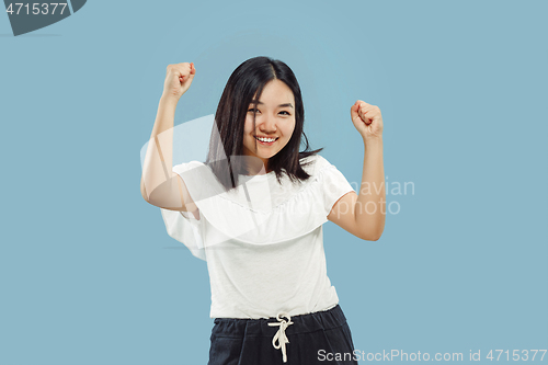 Image of Korean young woman\'s half-length portrait on blue background