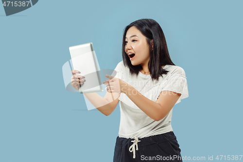 Image of Korean young woman\'s half-length portrait on blue background