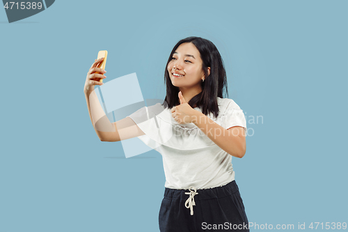 Image of Korean young woman\'s half-length portrait on blue background