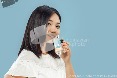 Image of Korean young woman\'s half-length portrait on blue background