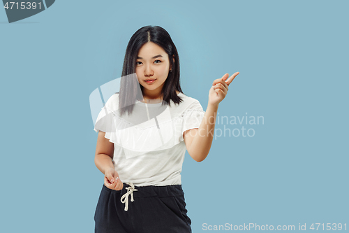 Image of Korean young woman\'s half-length portrait on blue background