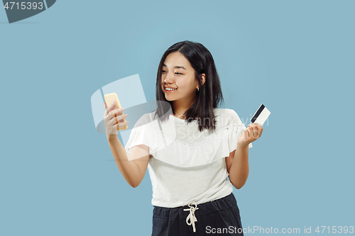 Image of Korean young woman\'s half-length portrait on blue background