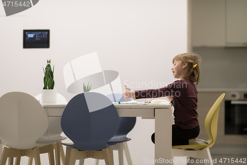 Image of little girl painting on canvas