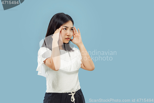 Image of Korean young woman\'s half-length portrait on blue background