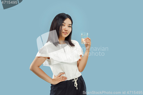 Image of Korean young woman\'s half-length portrait on blue background