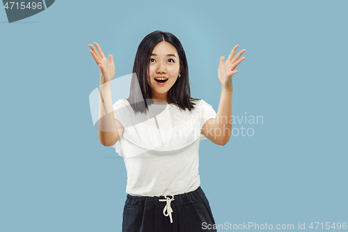 Image of Korean young woman\'s half-length portrait on blue background