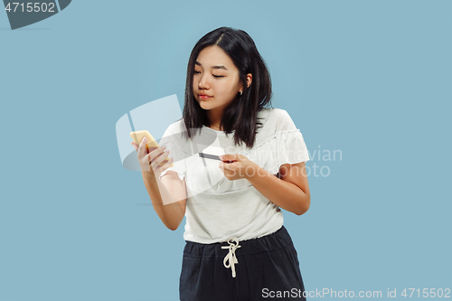 Image of Korean young woman\'s half-length portrait on blue background