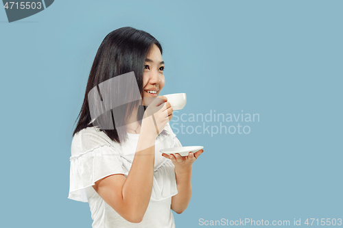 Image of Korean young woman\'s half-length portrait on blue background