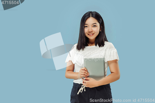 Image of Korean young woman\'s half-length portrait on blue background