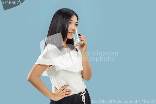 Image of Korean young woman\'s half-length portrait on blue background