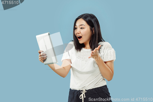 Image of Korean young woman\'s half-length portrait on blue background