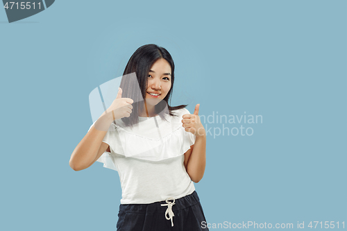 Image of Korean young woman\'s half-length portrait on blue background