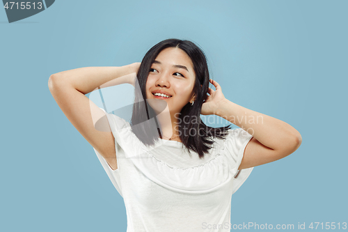 Image of Korean young woman\'s half-length portrait on blue background