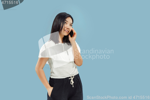 Image of Korean young woman\'s half-length portrait on blue background