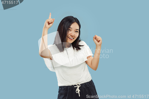 Image of Korean young woman\'s half-length portrait on blue background