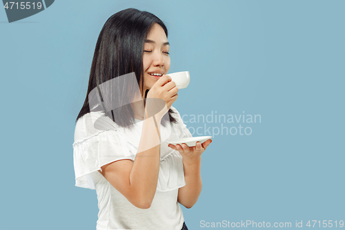 Image of Korean young woman\'s half-length portrait on blue background