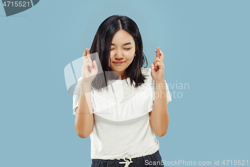 Image of Korean young woman\'s half-length portrait on blue background