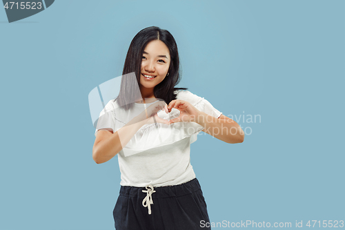 Image of Korean young woman\'s half-length portrait on blue background