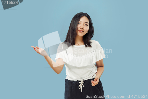 Image of Korean young woman\'s half-length portrait on blue background