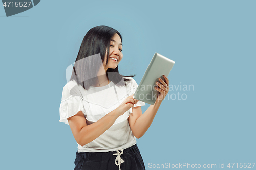 Image of Korean young woman\'s half-length portrait on blue background