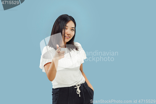 Image of Korean young woman\'s half-length portrait on blue background