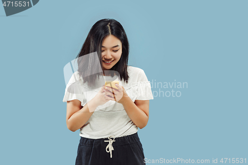 Image of Korean young woman\'s half-length portrait on blue background