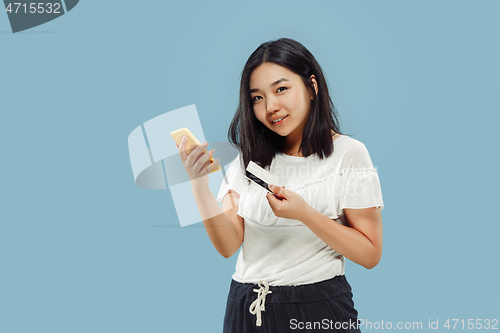 Image of Korean young woman\'s half-length portrait on blue background