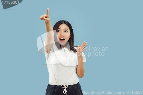 Image of Korean young woman\'s half-length portrait on blue background