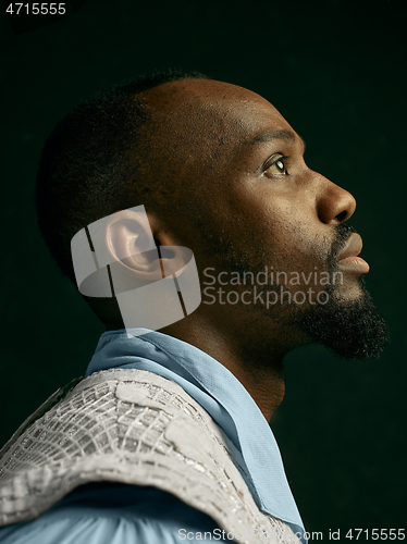 Image of Young man as a medieval knight on dark background