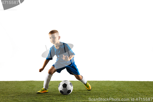 Image of Young boy as a soccer or football player on white studio background