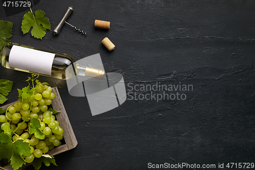 Image of Top view of tasty fruit plate with the wine bottle on the black stone