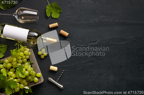 Image of Top view of tasty fruit plate with the wine bottle on the black stone