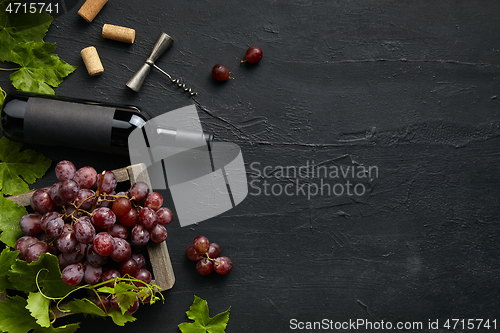 Image of Top view of tasty fruit plate with the wine bottle on the black stone