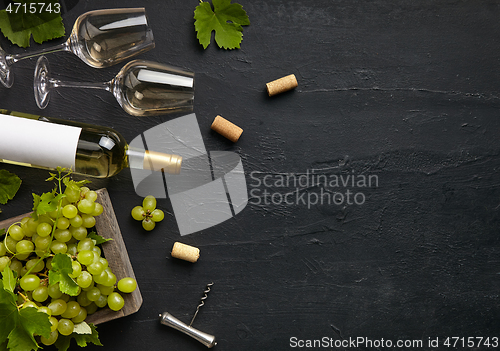 Image of Top view of tasty fruit plate with the wine bottle on the black stone