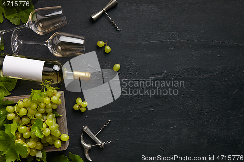 Image of Top view of tasty fruit plate with the wine bottle on the black stone