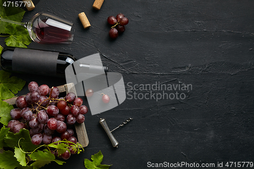 Image of Top view of tasty fruit plate with the wine bottle on the black stone